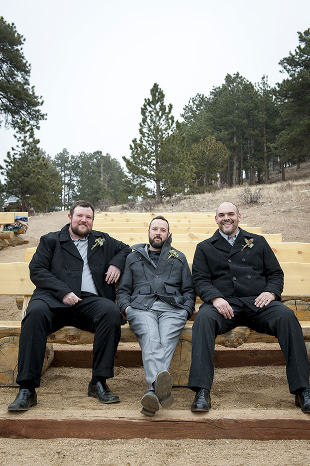 Groomsmen relaxing on the wooden pews