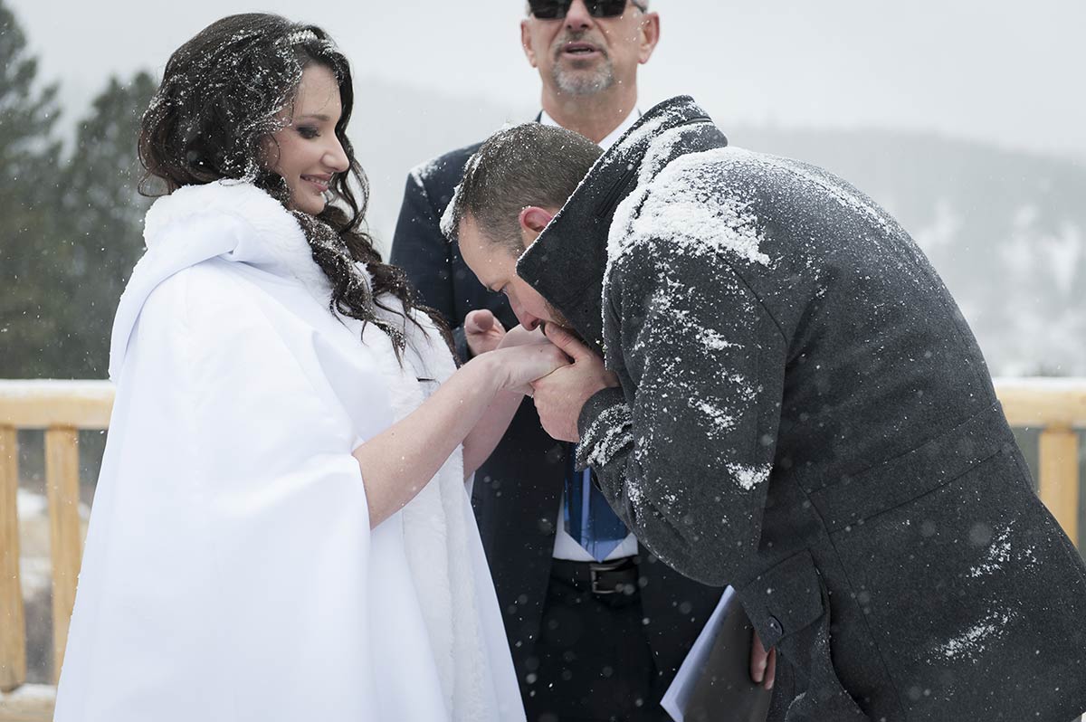 Groom kisses Bride's hands