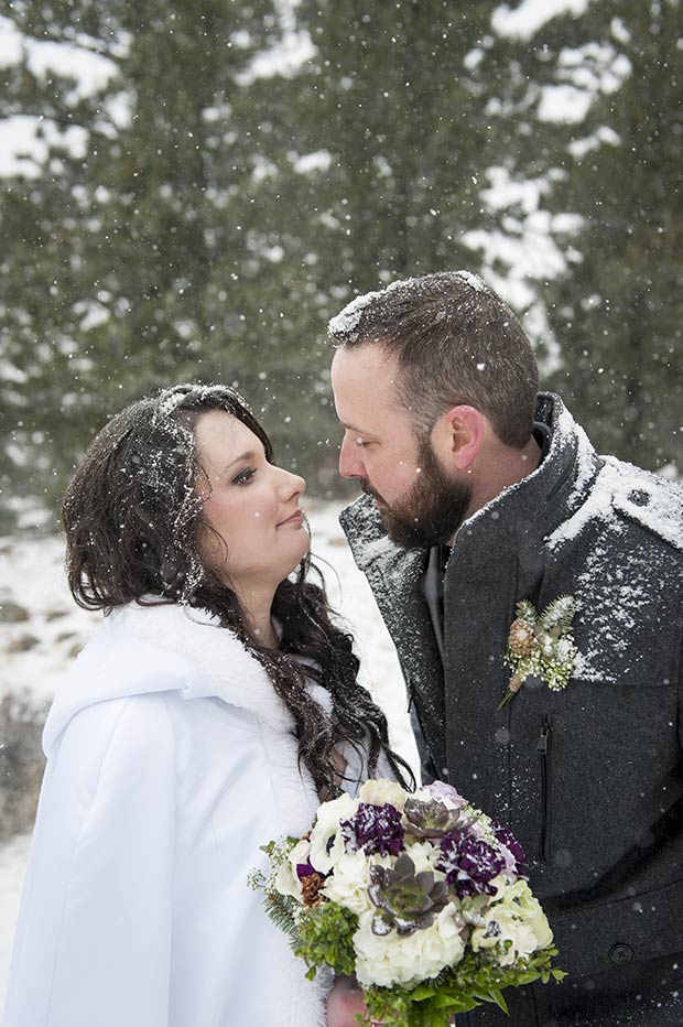 Nick and Chrissy kissing in the snow