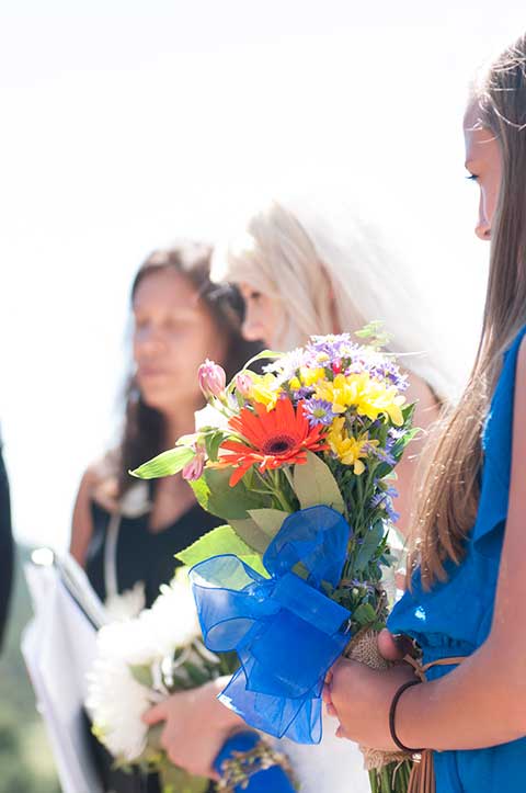 Kaylee holding her mom's flowers during the ceremony