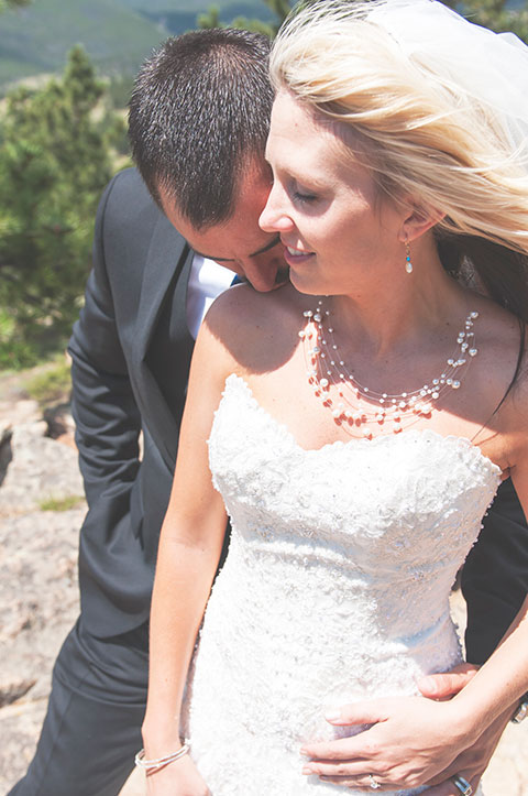 Jason kissing his new bride on the shoulder